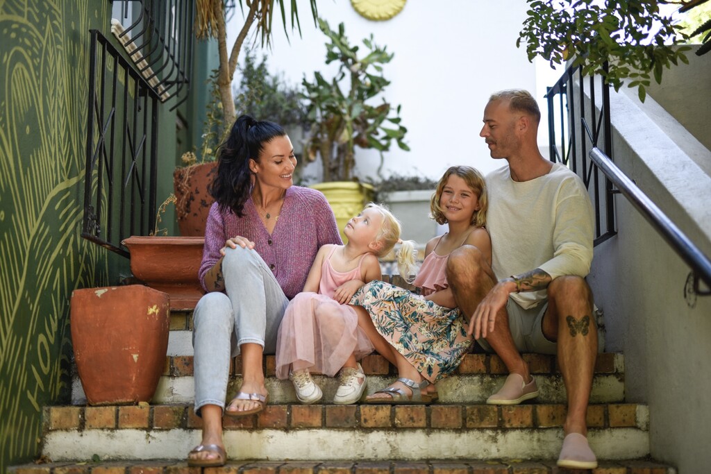 Family of four sitting on stairs in Cape Town.